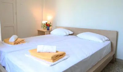 a bedroom with two beds with towels on them at house in the village near the sea in Maleme