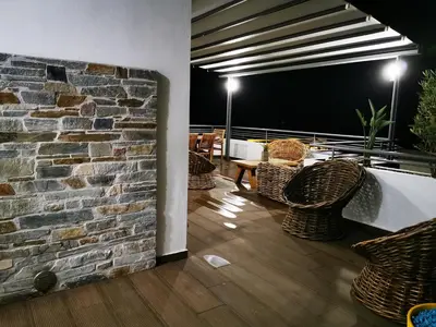 a room with chairs and a brick wall at Villa Patroklos in Daratso