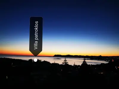 a sign with a sunset in the background at Villa Patroklos in Daratso