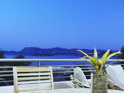 a table with chairs and a plant on a balcony at Villa Patroklos in Daratso