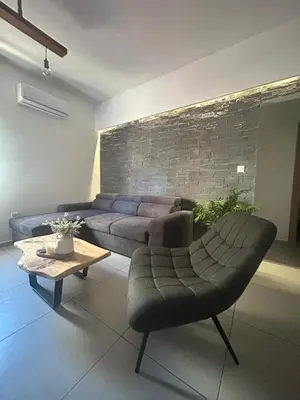 a living room with a couch and a table at Evis House in Chania Town