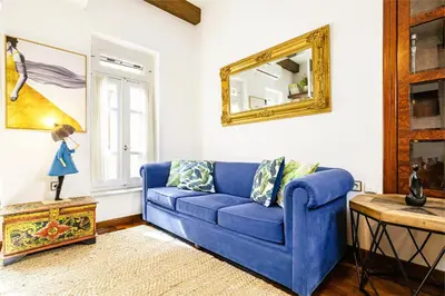 a blue couch in a living room with a mirror at Chanialiving Venetian Luxury House-near Plaza Parking in Chania Town