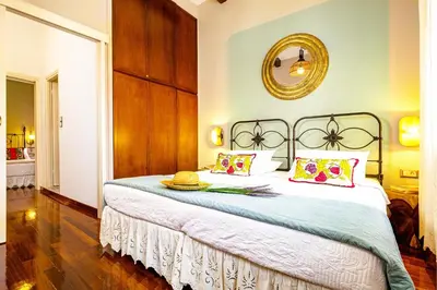 a bedroom with a large bed with a hat on it at Chanialiving Venetian Luxury House-near Plaza Parking in Chania Town