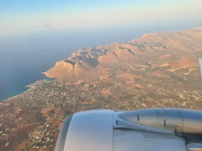 a view of a mountain from the wing of an airplane at Manolo s olive farm, apartment with seaview in Chania Town