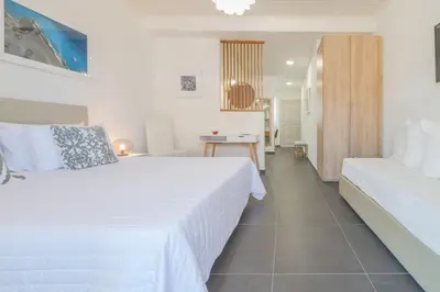 a hotel room with a bed and a desk at Rotunda Suites in Kalamaki Chanion