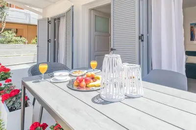a table with a plate of fruit and glasses of wine at Rotunda Suites in Kalamaki Chanion
