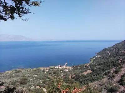 a view of the water from a hill at apartment over the sea Private place to swim in Ravdhoúkha