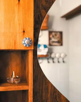 a wooden cabinet with a mirror in a room at Elia's House Traditional & Cozy by 8essentially in Kalyves