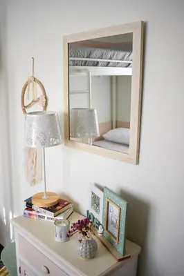 a mirror on a wall above a dresser with a lamp at Elia's House Traditional & Cozy by 8essentially in Kalyves