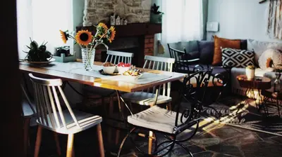 a living room with a table with chairs and a couch at Elia's House Traditional & Cozy by 8essentially in Kalyves