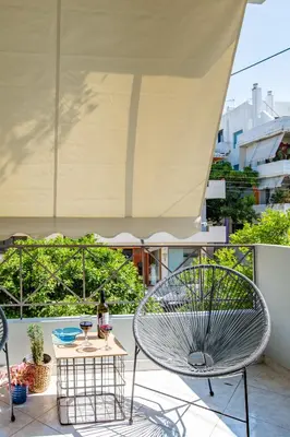 a patio with a chair and a table on a balcony at Nautilus charm city center apt with veranda in Chania Town