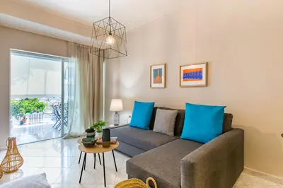 a living room with a couch and a table at Nautilus charm city center apt with veranda in Chania Town