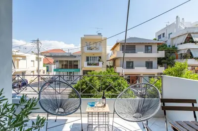 a balcony with two metal chairs and a table at Nautilus charm city center apt with veranda in Chania Town