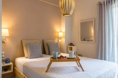 a bedroom with a bed with a tray of fruit on it at Nautilus charm city center apt with veranda in Chania Town