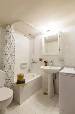 a bathroom with a sink and a toilet and a bath tub at Nautilus charm city center apt with veranda in Chania Town