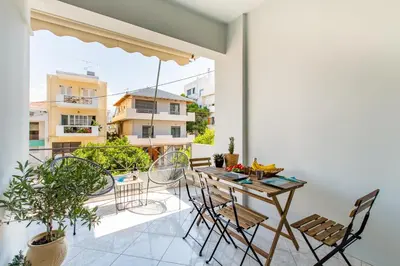 a balcony with a table and chairs on it at Nautilus charm city center apt with veranda in Chania Town