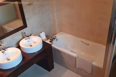 a bathroom with two sinks and a bath tub at Double View Apartment in Agia Marina Nea Kydonias
