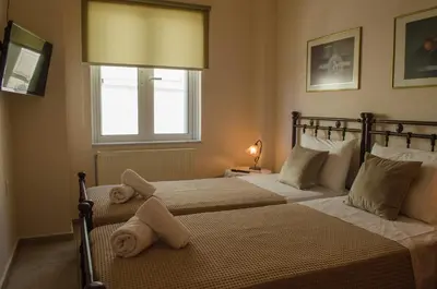 a bedroom with two beds with towels on them at Villa Aretaki in Kalamaki Chanion