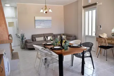 a dining room and living room with a table and chairs at House near Balos in Kissamos in Kissamos