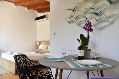 a dining table with a bottle of wine and glasses at House near Balos in Kissamos in Kissamos