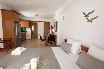a kitchen and a living room with a bed in a room at Camara Studios in Chania Town