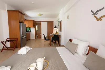 a kitchen and a living room with a bed in a room at Camara Studios in Chania Town
