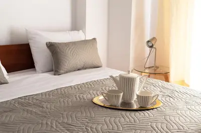 a bed with two cups on a tray on it at Camara Studios in Chania Town