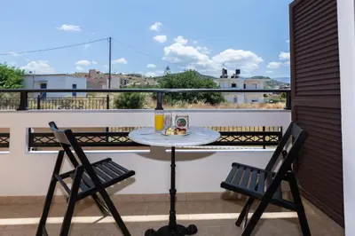 a table and two chairs on a balcony with a view at Anastellar in Kissamos