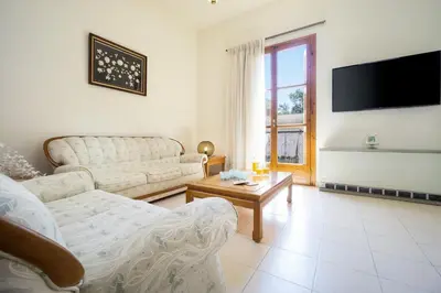 a living room with two couches and a tv at Metropolis House in Chania Town