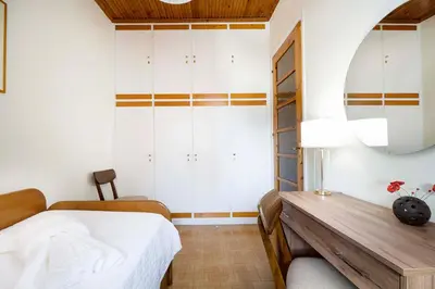 a bedroom with a bed and a desk and a mirror at Metropolis House in Chania Town