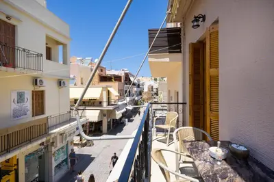 a balcony of a building with tables and chairs at Metropolis House in Chania Town