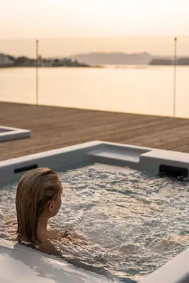 a little girl swimming in a jacuzzi tub at Domus Aqua in Kato Daratso