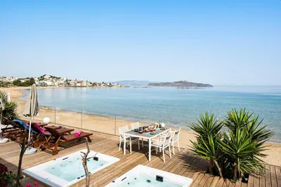 a balcony with a table and chairs and the beach at Domus Aqua in Kato Daratso