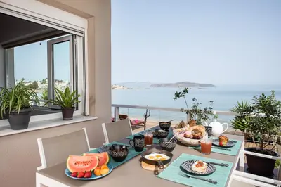 a table with food on it with a view of the ocean at Domus Aqua in Kato Daratso
