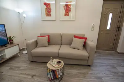 a living room with a couch and a table at Pasiphae New Apartment sea & city in Chania Town