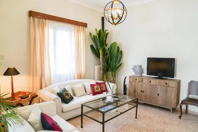 a living room with a white couch and a tv at Casa Armada in Chania Town