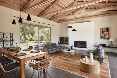 a living room with a table and chairs and a fireplace at Villa Fuerte & Weddings Estate in Alikianós