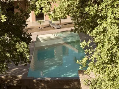 an overhead view of a swimming pool through trees at Villa Fuerte & Weddings Estate in Alikianós