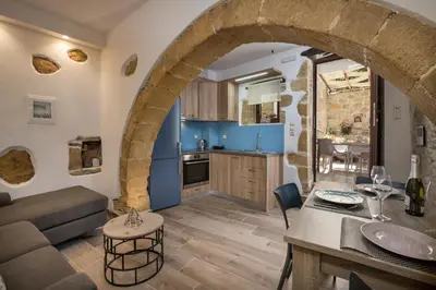 a kitchen and living room with an archway at Doro Villas in Kissamos