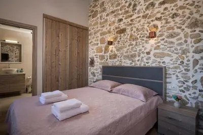 a bedroom with a bed with two towels on it at Doro Villas in Kissamos