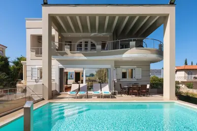 a villa with a swimming pool and a house at Cedar Tree Villa in Kounoupidhianá