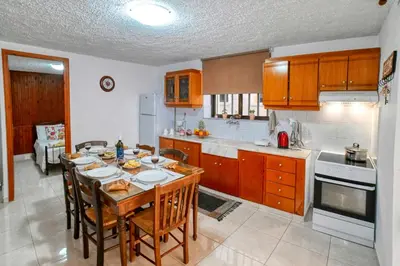 a kitchen with a table and chairs and a kitchen with at Kiki's House near Falassarna and Balos in Plátanos