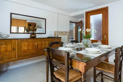 a dining room with a table and chairs and a mirror at Kiki's House near Falassarna and Balos in Plátanos