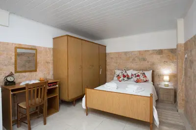 a bedroom with a bed and a desk and a desk at Kiki's House near Falassarna and Balos in Plátanos