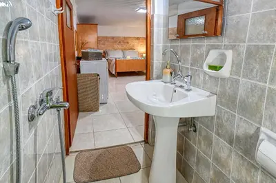 a bathroom with a sink and a shower at Kiki's House near Falassarna and Balos in Plátanos