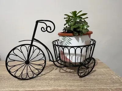 a black metal cart with a potted plant on a table at Marial City Apartment Chania in Chania Town