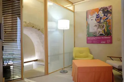 a room with a chair and a table and a lamp at The Journey Design Home Chania in Chania Town