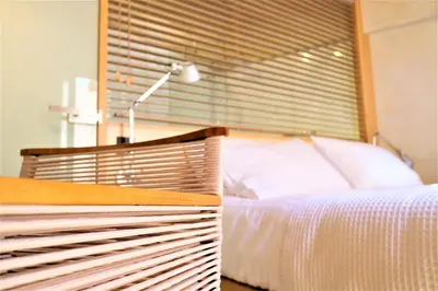 a bedroom with a white bed and a lamp at The Journey Design Home Chania in Chania Town