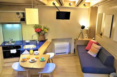 a small living room with a table and a couch at The Journey Design Home Chania in Chania Town