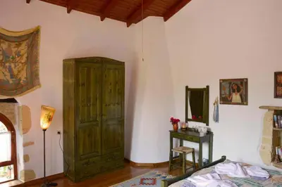 a bedroom with a large wooden cabinet and a bed at Apanemia in Vamos
